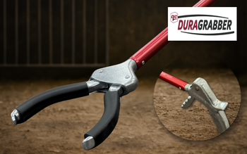 Close-up of the DURAGrabber™ tool with QC Supply branding on a barn floor background.